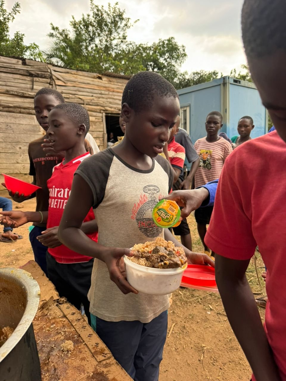 Children eating a hot meal together in the dining hall
